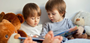 two young children sat reading together