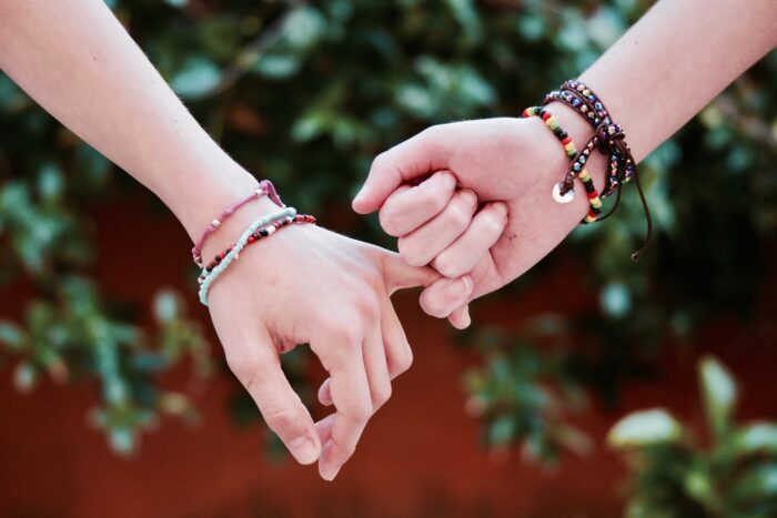young couple's hands linking